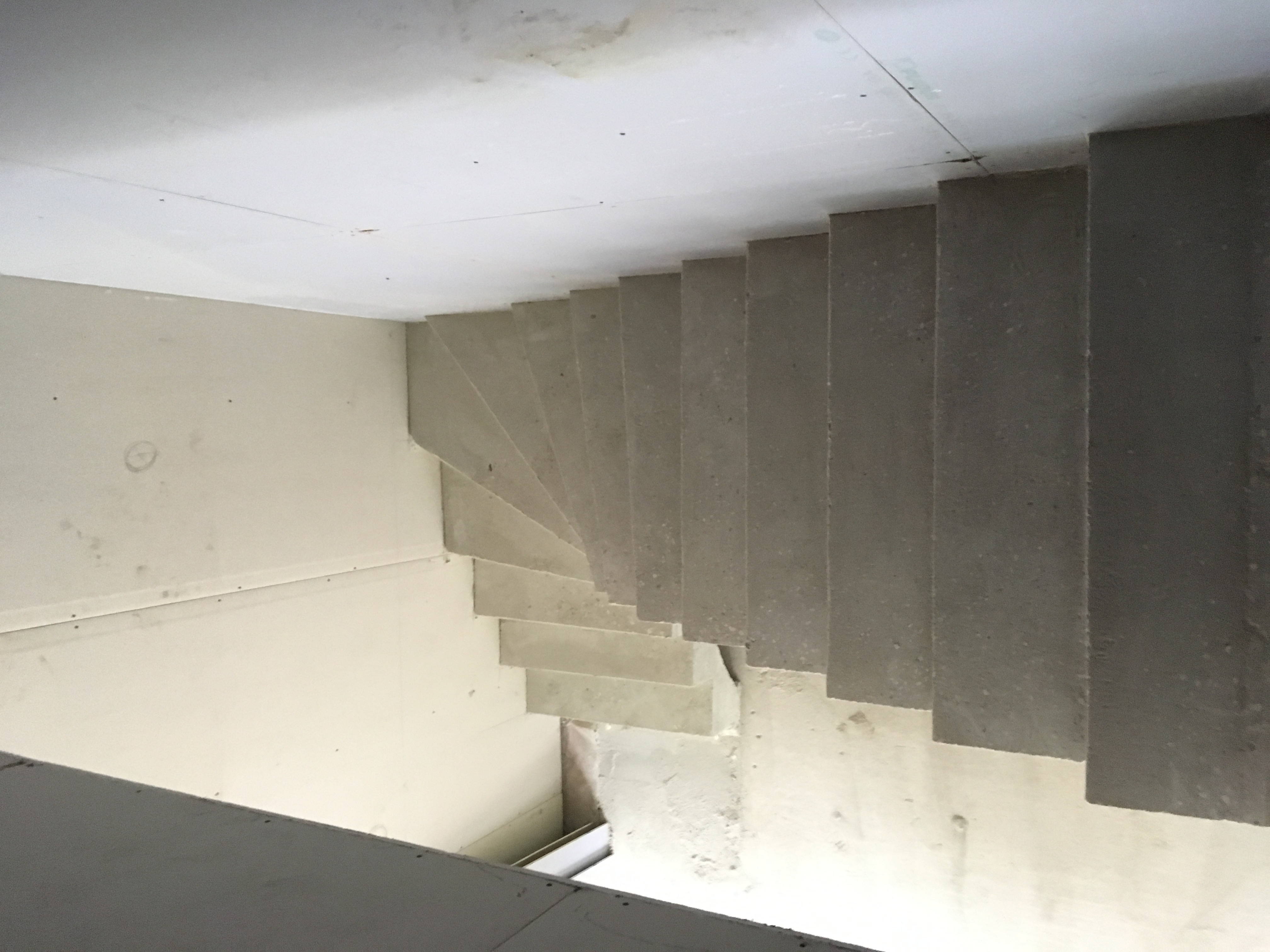 elégant escalier à paillasse un quart tournant en béton brut de décoffrage  à Talence près de Bordeaux  pour un constructeur